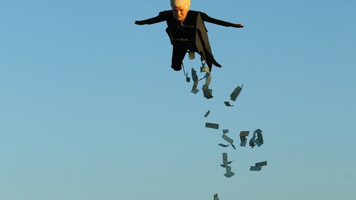 A remote-control plane resembling Donald Trump releases fake money as it flies over a beach in Southern California.