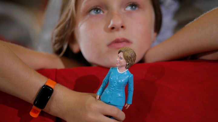 Belle Shefrin, 9, holds a doll of Hillary Clinton while listening to Clinton speak at a campaign rally in Ohio in 2016.