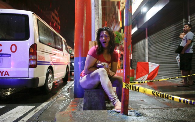 A woman cries after her husband was shot dead by unidentified gunmen riding motorcycles in Manila. 