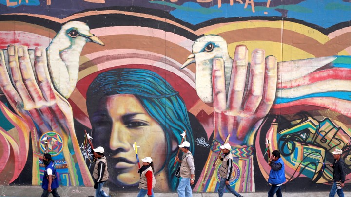 Indigenous Colombians rally for an imminent resolution to the nation’s peace agreement during a march with white flowers in Bogota, Colombia, October 12, 2016.