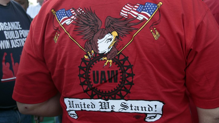 A United Auto Workers union member wearing a shirt with the union's logo