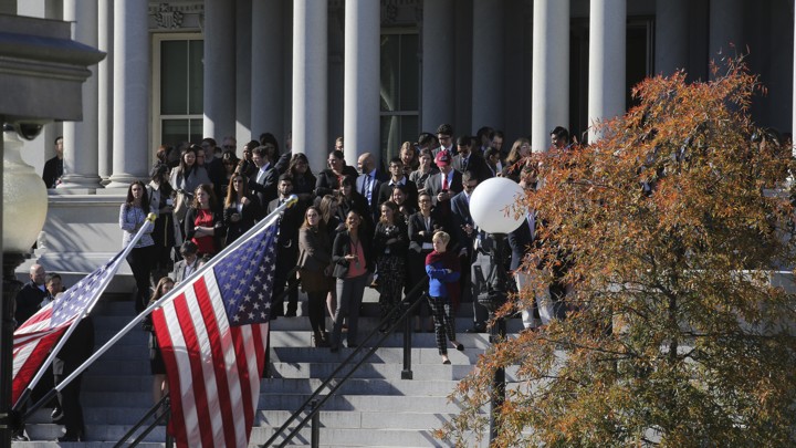 Onlookers hoping to get a view of President-elect Donald Trump stand outside the White House in Washington, D.C., on November 10.