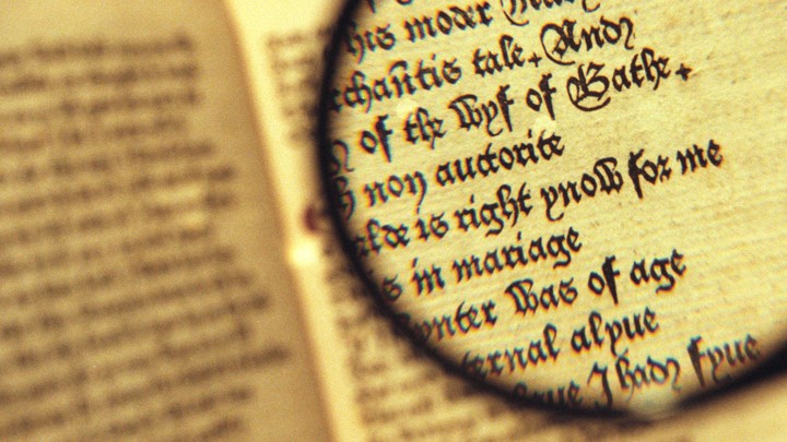 A magnifying glass hovers over an open copy of "The Canterbury Tales"