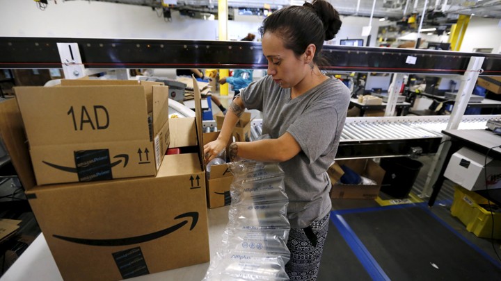 Monica Galvan secures customers' orders with air cushions at the Amazon Fulfillment Center in Tracy, California.
