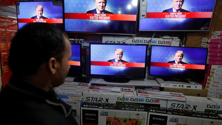 An Afghan man watches the broadcasting of the 2016 U.S. presidential election results on TV in Kabul, Afghanistan November 9, 2016.