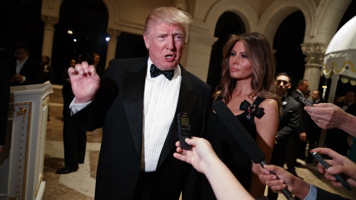 President-elect Donald Trump speaks to reporters as his wife, Melania, looks on.
