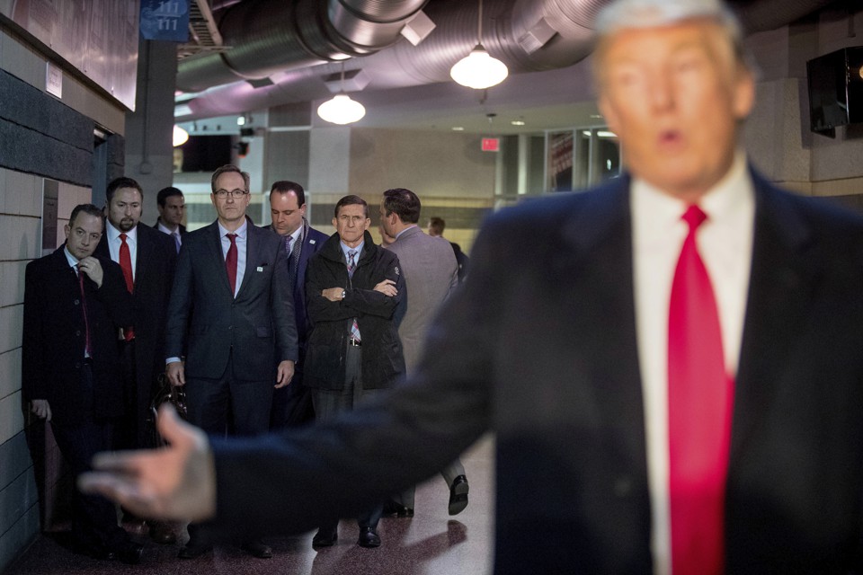 President-elect Donald Trump speaks in front of several of his advisers