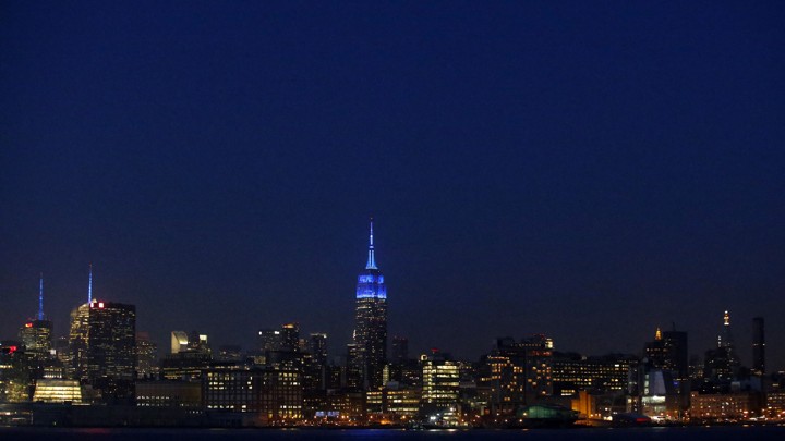 The New York skyline at night, with the Empire State Building lit up for World Autism Awareness Day