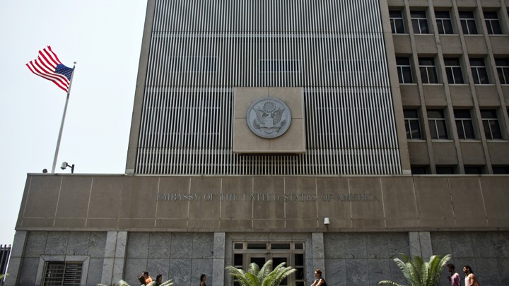 Pedestrians walk past the U.S. embassy in Tel Aviv.