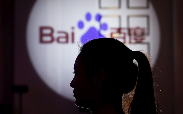 A woman is silhouetted against the Baidu logo
