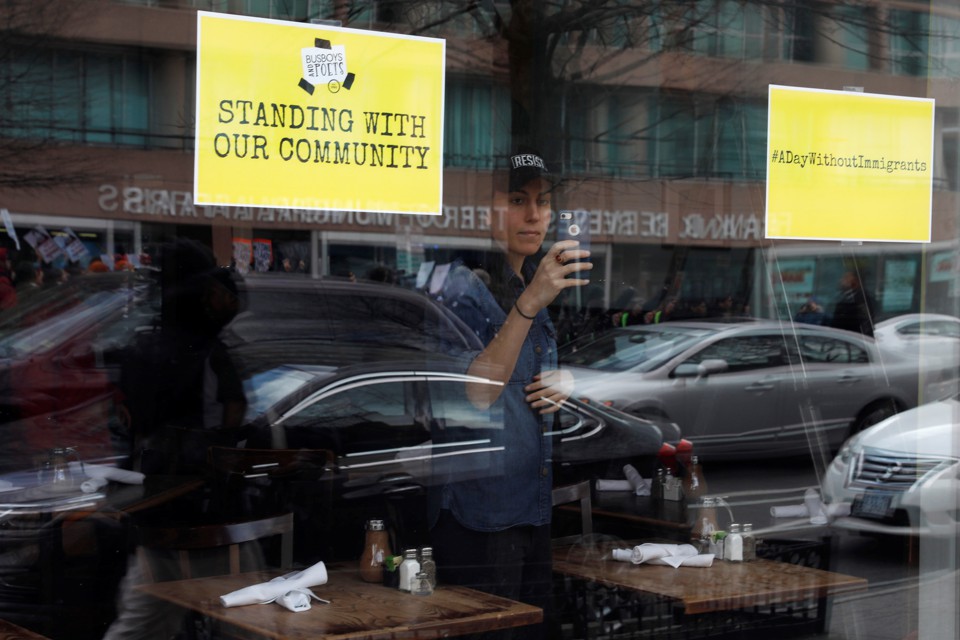 A store displays signs in its windows supporting the "A Day Without Immigrants" strike on February 16.