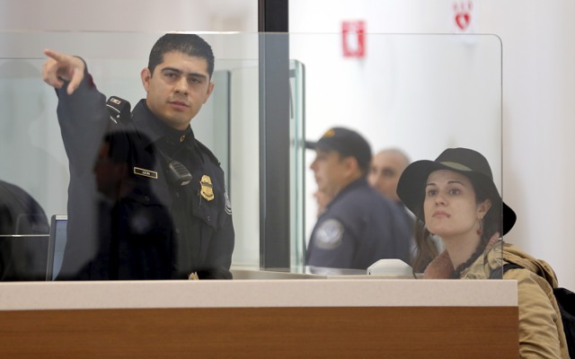 A traveler is directed as she passes through U.S. Customs and Immigration.
