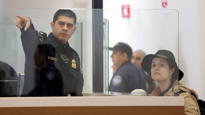 A traveler is directed as she passes through U.S. Customs and Immigration.
