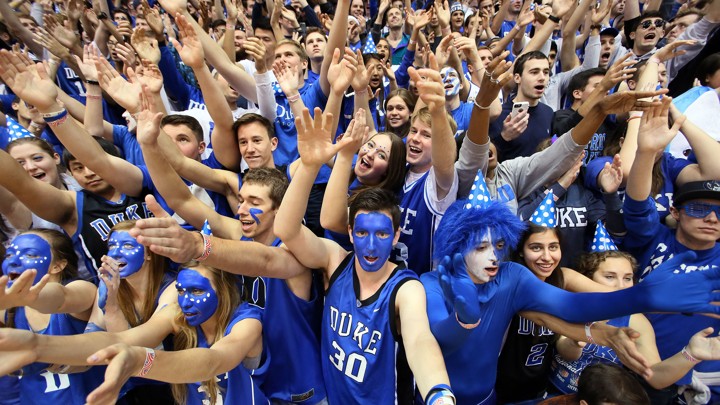 Fans with blue face paint and spirited outfits cheer on the Duke Blue Devils.