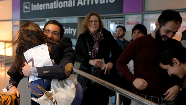 Behnam Partopour, a student from Iran, is greeted by his sister Bahar at Logan Airport after he cleared U.S. customs and immigration on an F1 student visa in Boston.