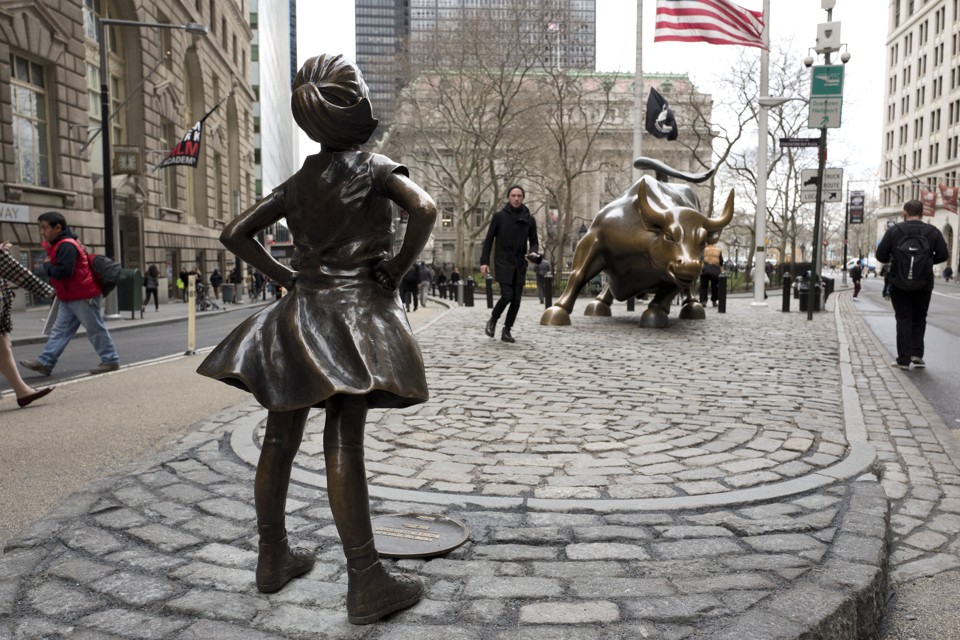 The "Fearless Girl" statue faces down Wall Street's famous Charging Bull.
