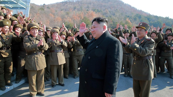 North Korean leader Kim Jong Un waving to North Korean officers during the launch of ballistic missiles