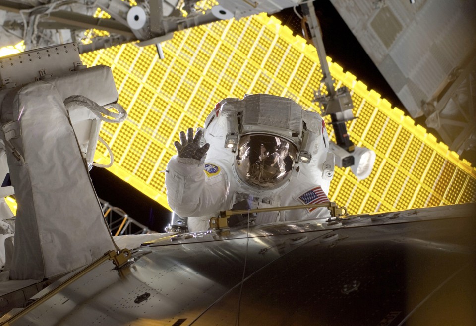Astronaut Nicole Stott waves during a spacewalk outside the International Space Station in 2009. 