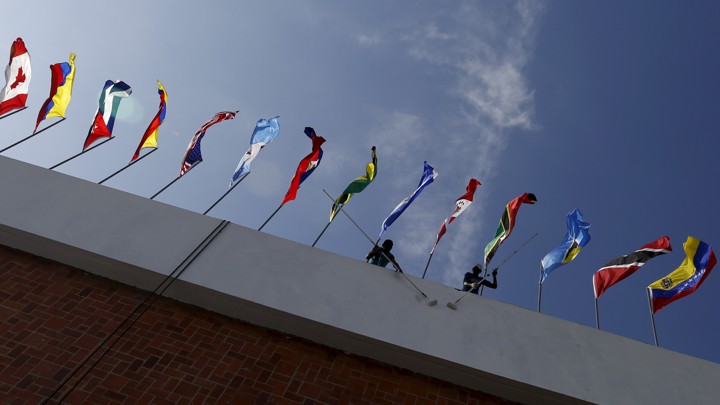 A photo taken from below a row of flags from around the world