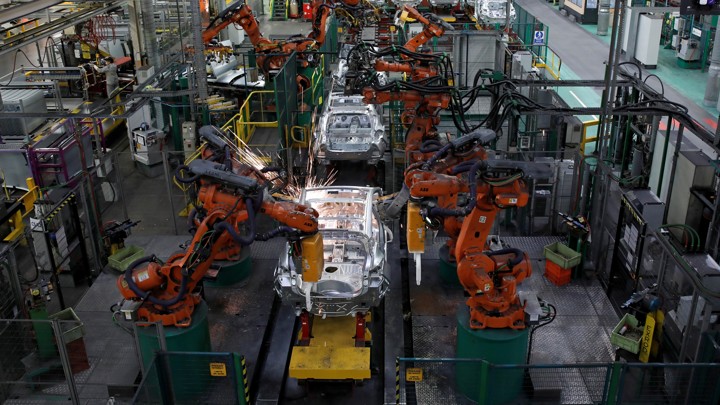 Robots put together cars at a factory in France.
