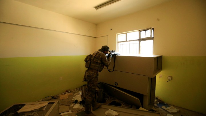 A sniper of the Iraqi rapid response forces takes his position during a battle with Islamic State militants in Mosul, Iraq, on March 7, 2017.