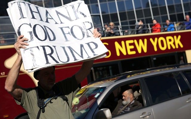 A man holds a pro-Trump sign in New York.