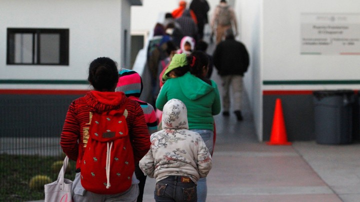 Immigrants from Central America and Mexican citizens prepare to cross into the U.S. to apply for asylum in Tijuana, Mexico.