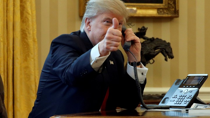 President Donald Trump gives a thumbs-up as he waits to speak by phone with Saudi Arabia's King Salman.