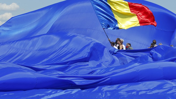 Workers arrange Romania's national flag during a Guinness World Record attempt for the world's biggest national flag.