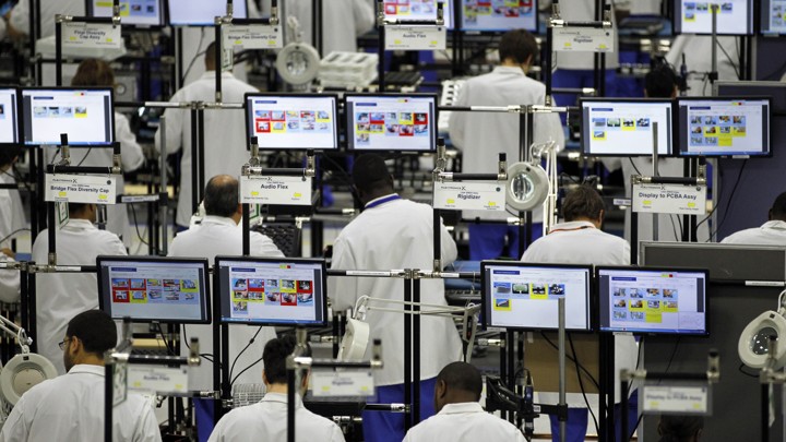 Workers in Fort Worth, Texas assemble Motorola phones at the Flextronics plant.