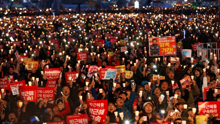 Protesters hold candles as they celebrate the impeachment of South Korea's ousted leader Park Geun Hye.
