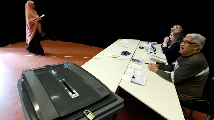 A woman arrives at a poll station to cast her vote in the Dutch general election in The Hague, Netherlands on March 15, 2017.