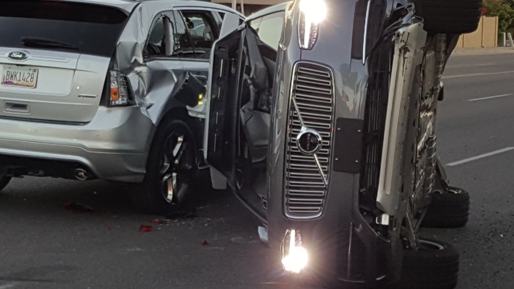 A self-driven Uber-owned Volvo flipped on its side after a collision in Tempe, Arizona. Police say Uber’s car did not cause the crash.