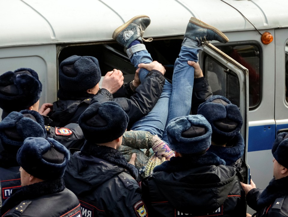 Police officers detain an opposition supporter during a rally in Vladivostok, Russia.