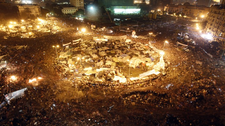 Anti-government protesters celebrate inside Tahrir Square after the announcement of Egyptian President Hosni Mubarak's resignation in Cairo February 11, 2011.