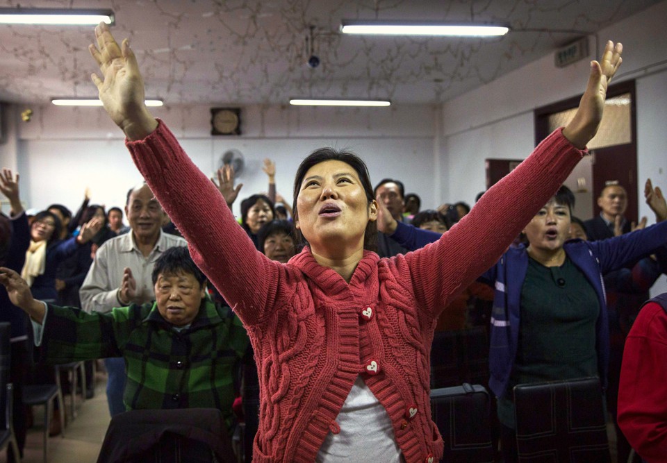 A Chinese Christian woman sings during a prayer service at an underground Protestant church in Beijing.