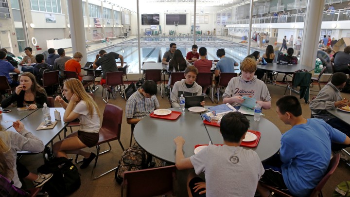 Students eat lunch in a cafeteria