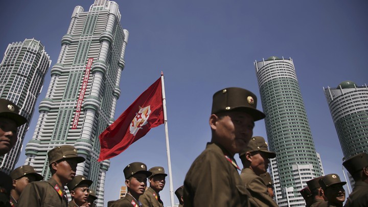 North Korean military soldiers walk along the Ryomyong residential area, a collection of more than a dozen apartment buildings just after attending its official opening ceremony on April 13, 2017, in Pyongyang, North Korea.