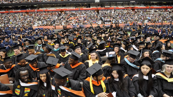 A group of college students in graduation caps, gowns, and stoles.