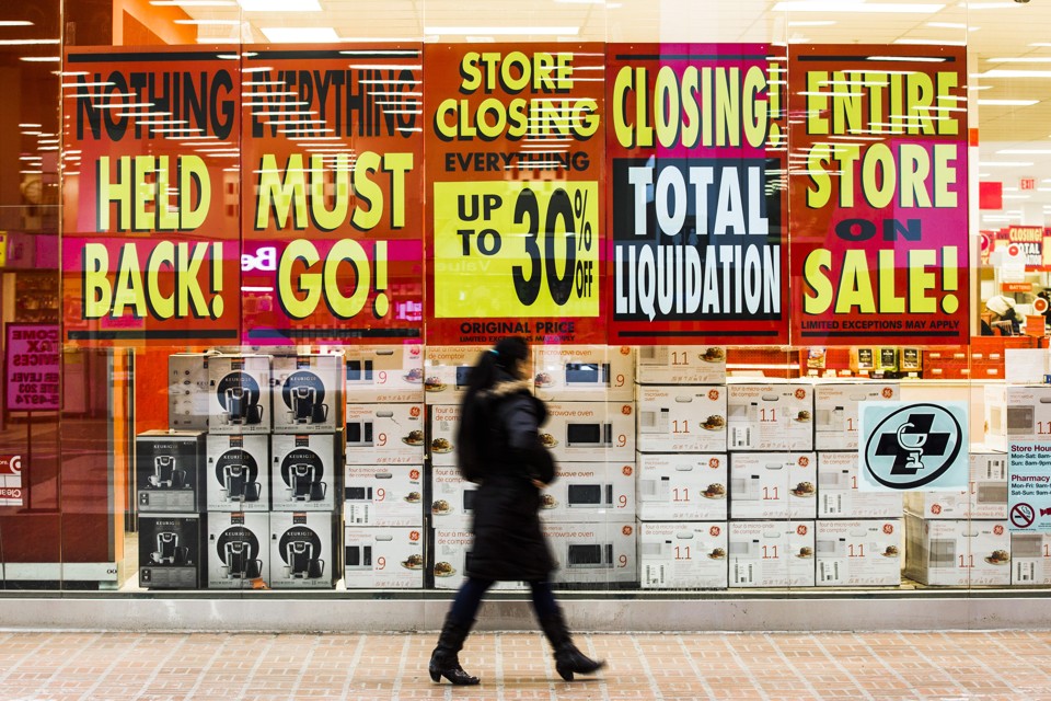 A retail store with signs advertising a pre-closing clearance sale