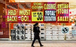 A retail store with signs advertising a pre-closing clearance sale