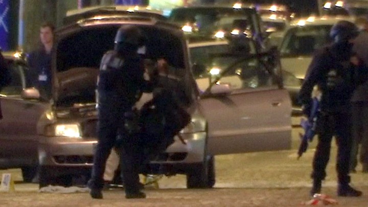 Police stand near the car used by the attacker on the Champs Elysees in Paris on April 20.