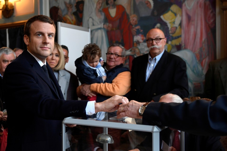Emmanuel Macron casts his ballot in the first round of French presidential election at a polling station in Le Touquet, France on April 23, 2017.