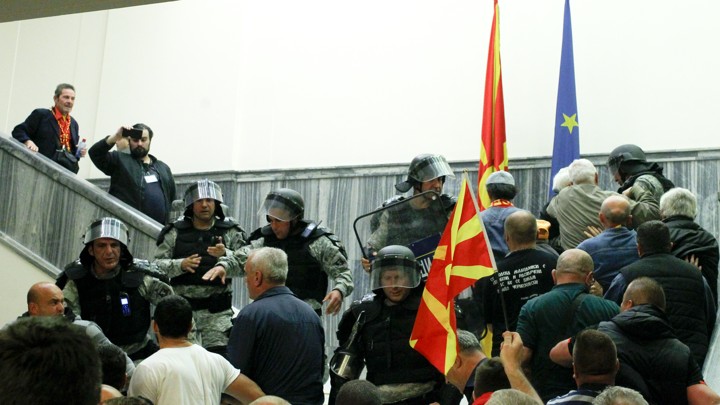 Police try to stop protesters entering Macedonia’s parliament after the governing Social Democrats and ethnic Albanian parties voted to elect an Albanian as parliament speaker in Skopje, Macedonia.