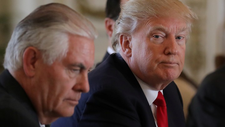 President Donald Trump sits next to Secretary of State Rex Tillerson the day after he ordered a strike on Syria.