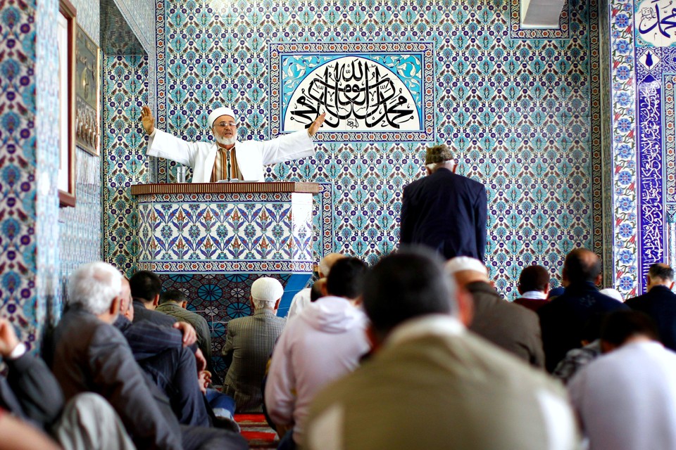 An imam holds Friday prayers at the Central Mosque in the German town of Hamburg