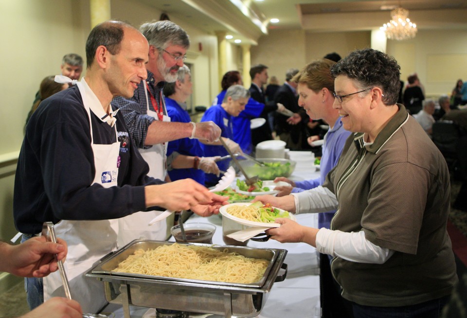 Maine's former governor John Baldacci, left, serves spaghetti at a fundraising event to benefit the Preble Street Resource Center, an agency that helps the homeless, in 2010.