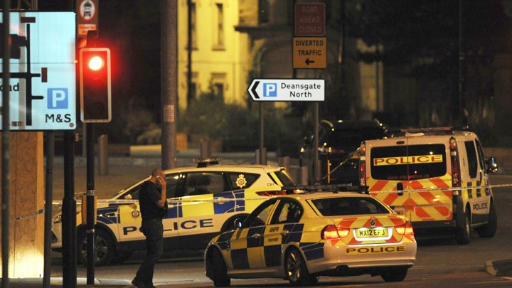 Armed police block a road near to the Manchester Arena in central Manchester, England, on May 23, 2017.
