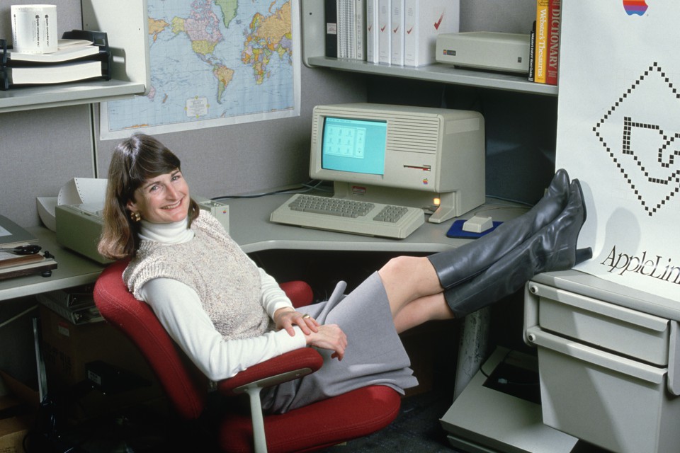 An Apple employee poses with a personal computer in 1986.