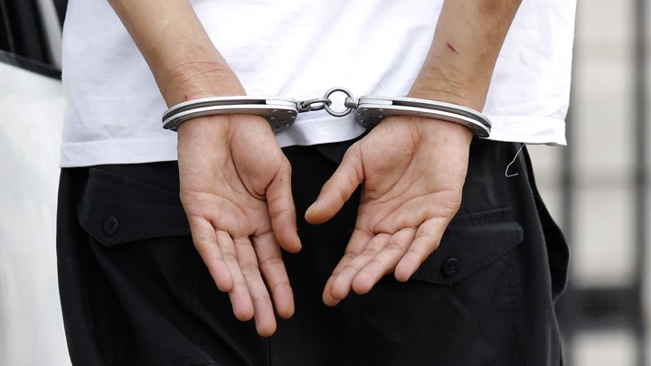Someone's hands in handcuffs